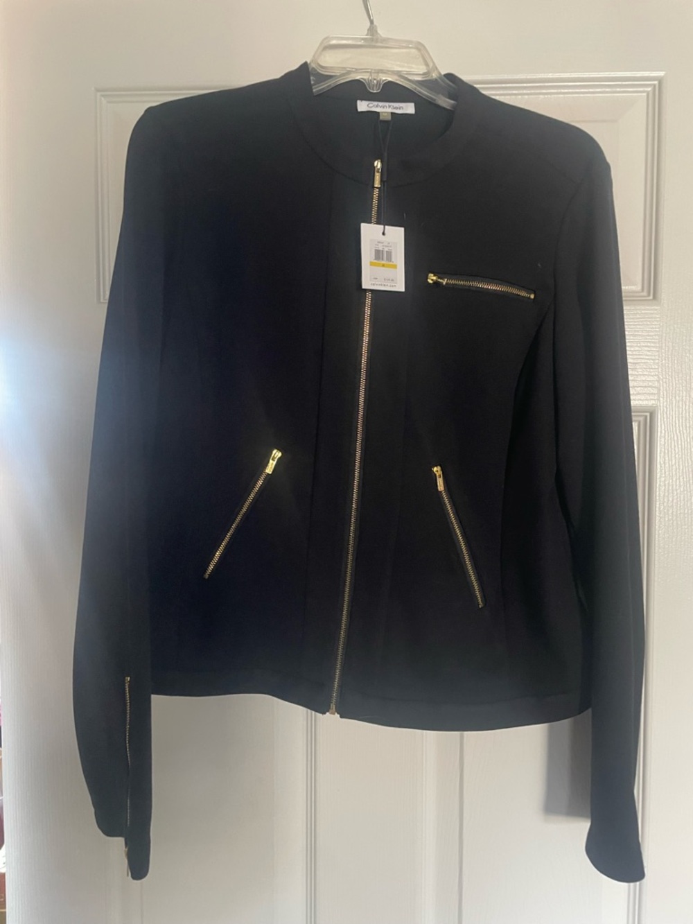 Calvin Klein Black Leather suit Jacket with Gold Zippers and matching skirt.